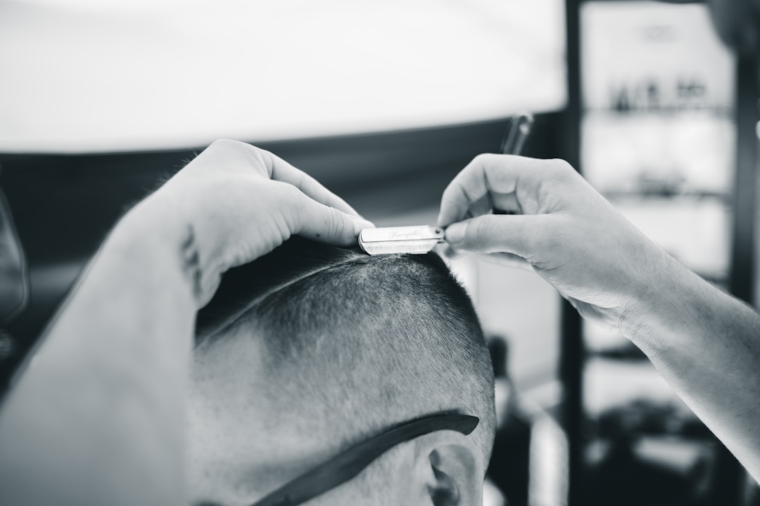 Professional barber cutting military buzz fade