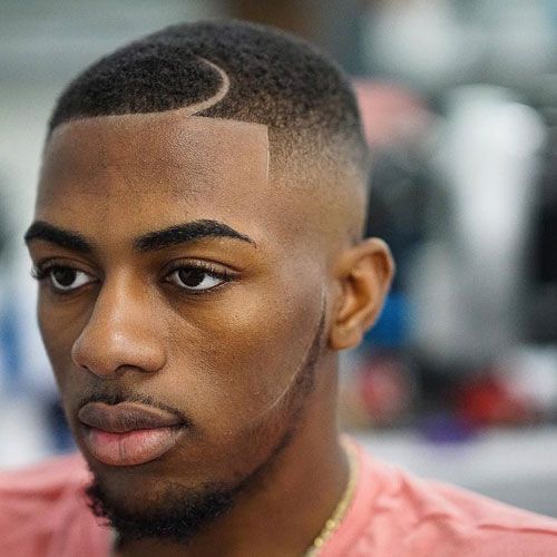 Professional barber refining low fade blend with clippers