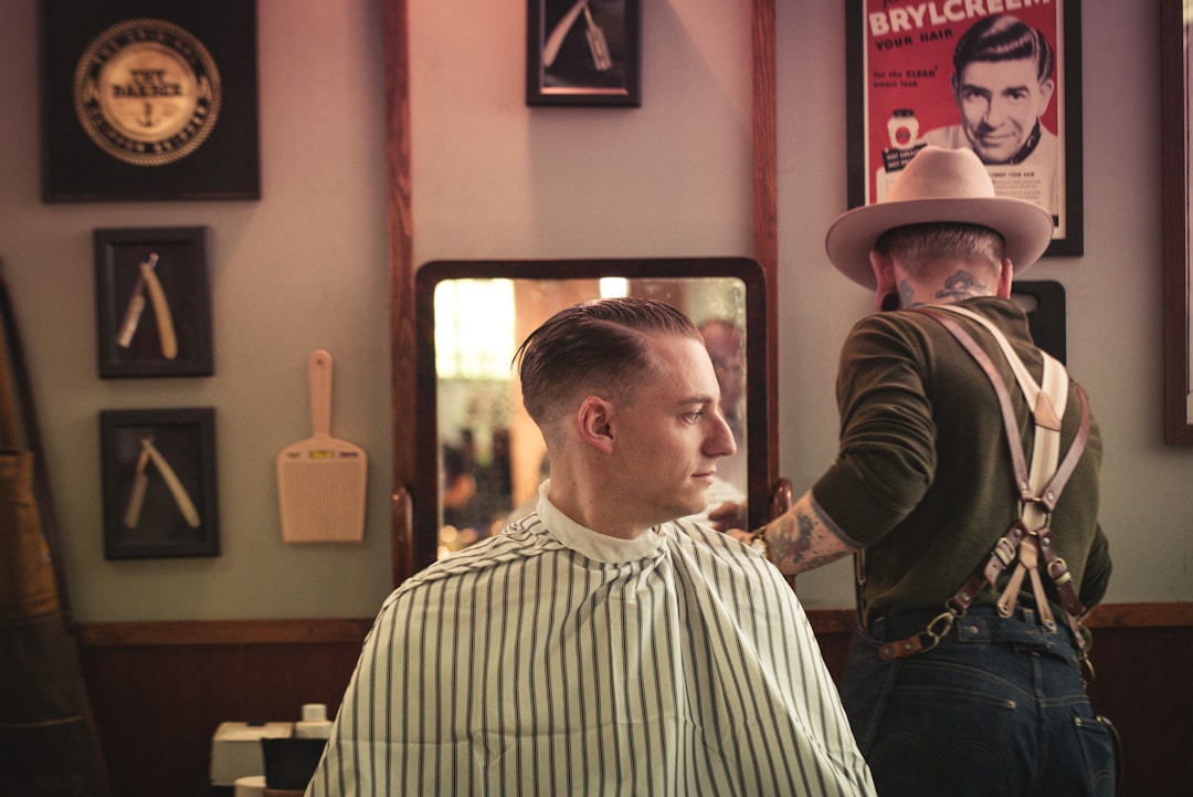 Low fade haircut style variations showcasing conservative elegance and professional styling options in traditional barbershop environment